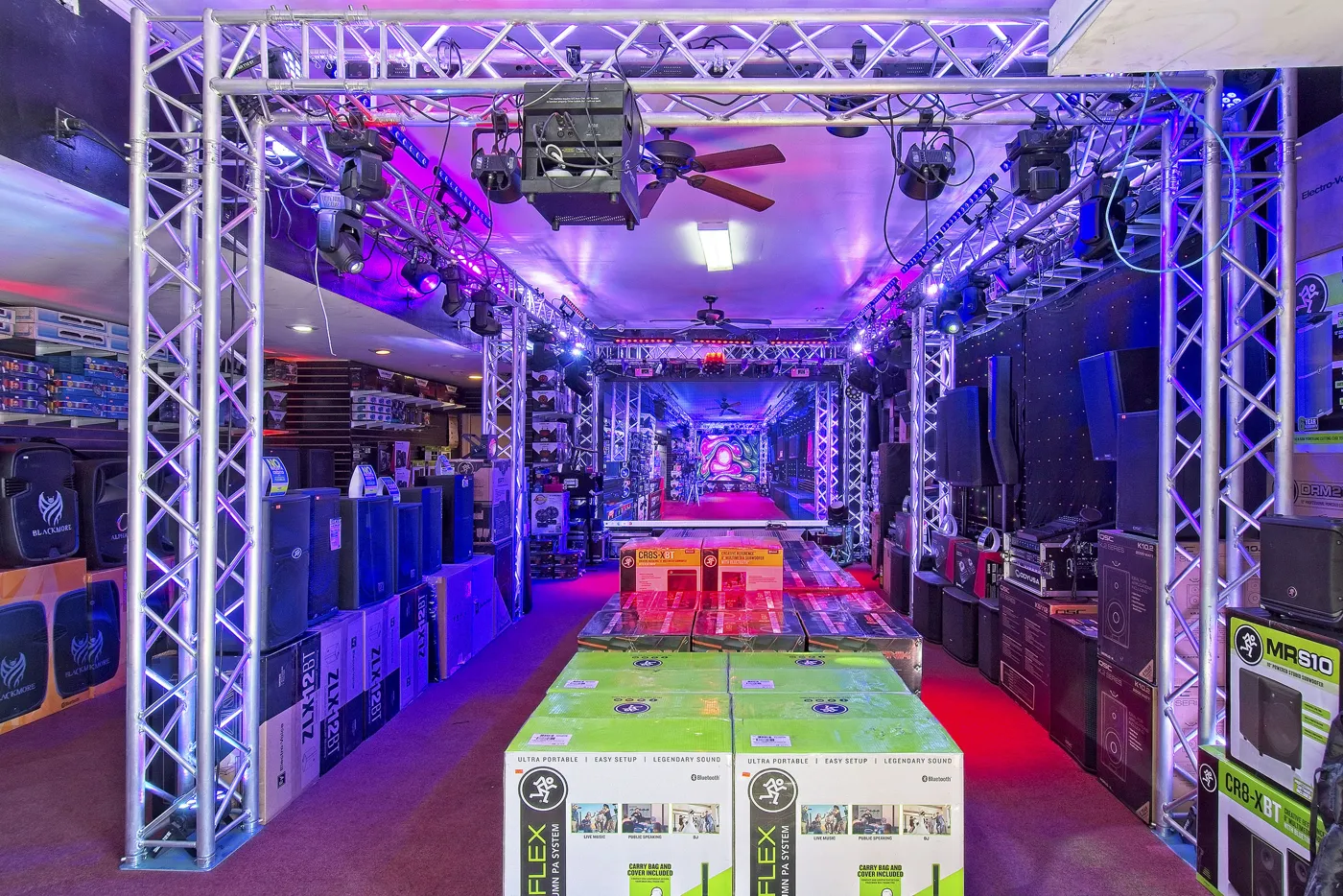 DJ floor with truss lighting, Electro-Voice and Mackie speakers
