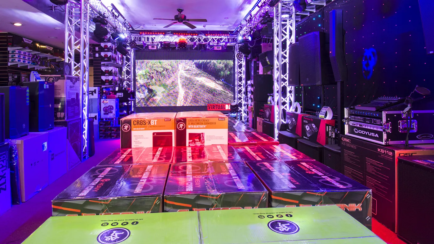 DJ stage area with Mackie subwoofers, QSC KS112 and a VirtualDJ screen
