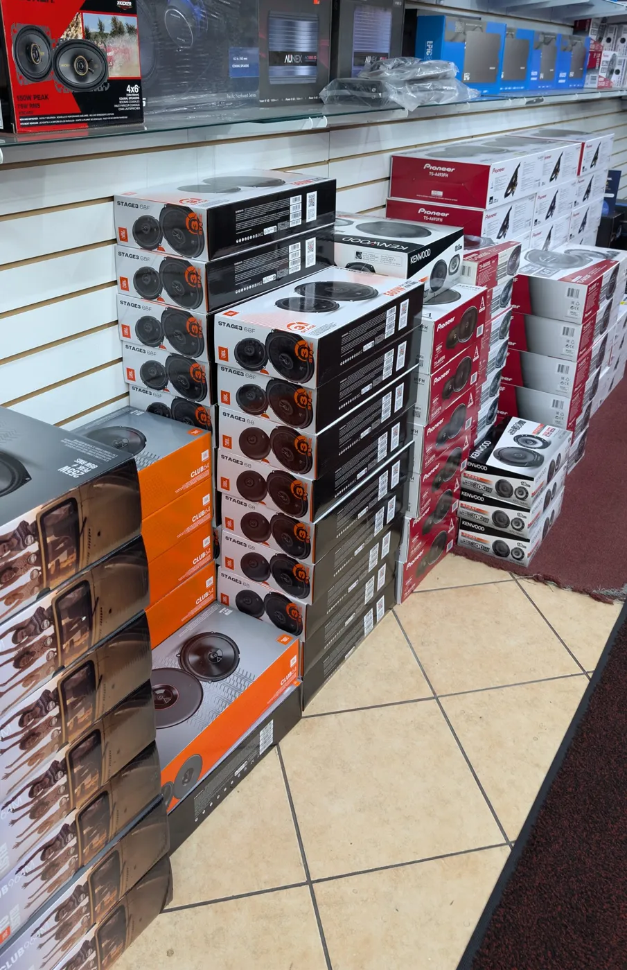 JBL Stage3, Pioneer and Kenwood speaker boxes stacked by the counter