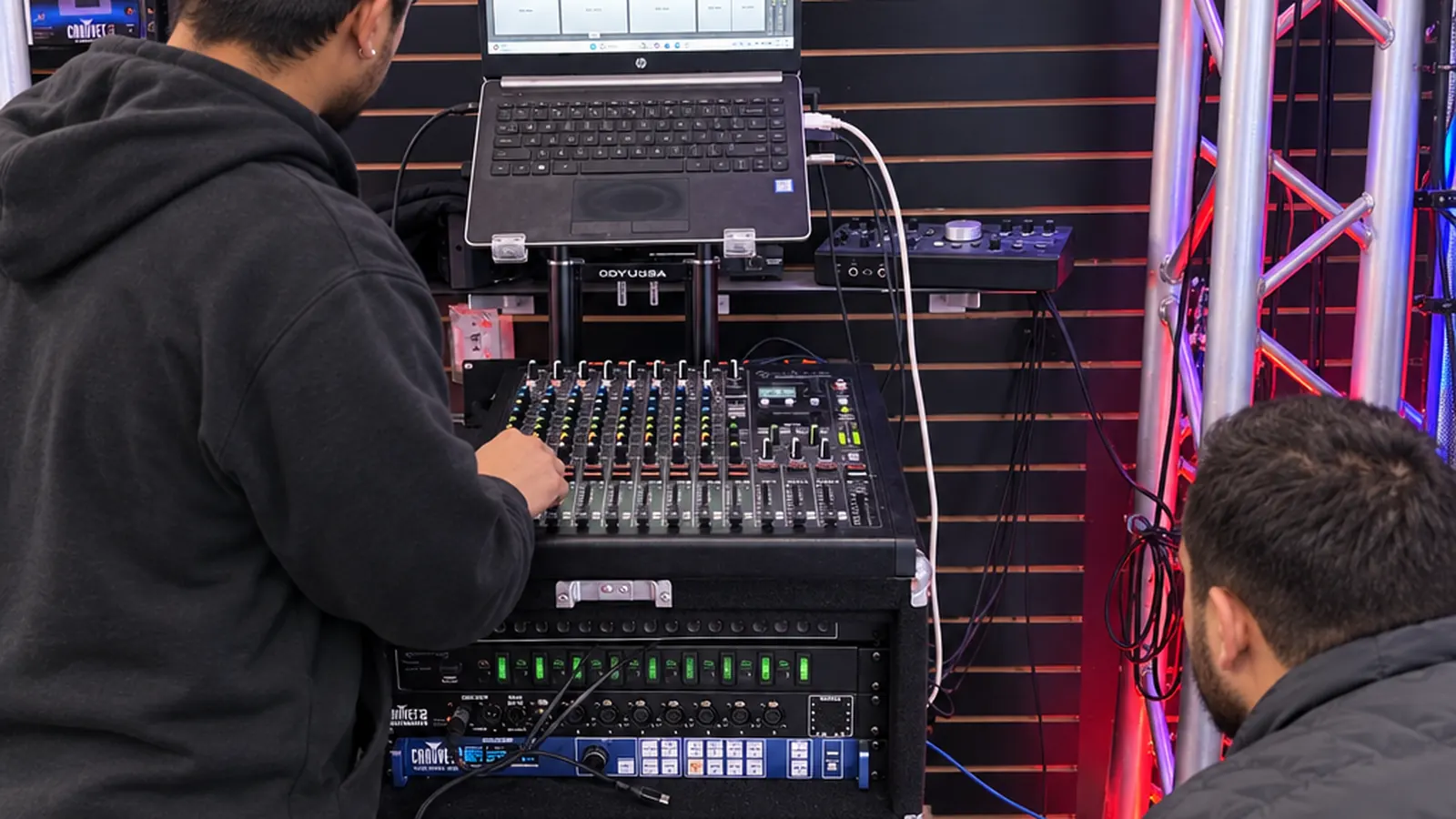 Marina del Rey drive-in: a customer at the DJ booth with a mixer and laptop on the truss stand at DJ Custom Audio in South Gate